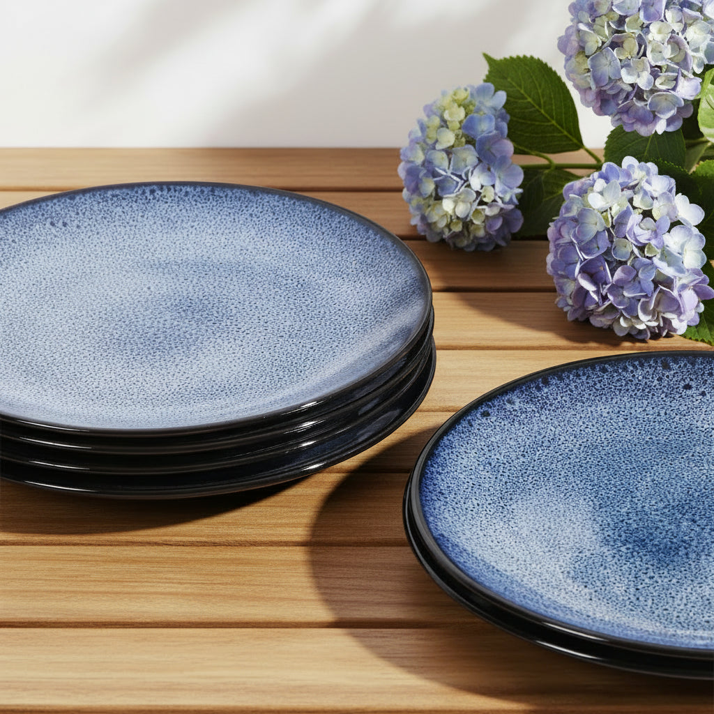 Set of blue ceramic plates on a teak surface with hydrangea