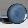 Set of blue ceramic plates with a textured finish on a white background