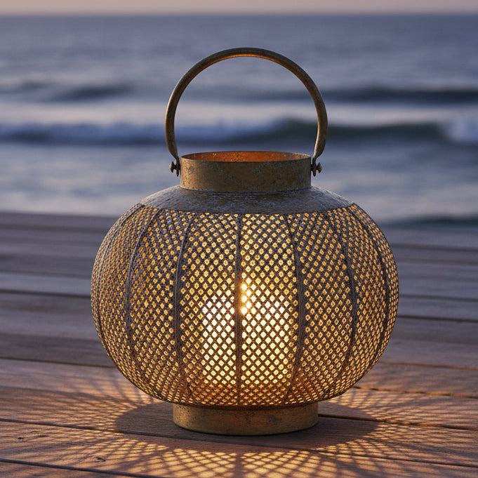 Decorative metal lantern with a textured surface on a white background