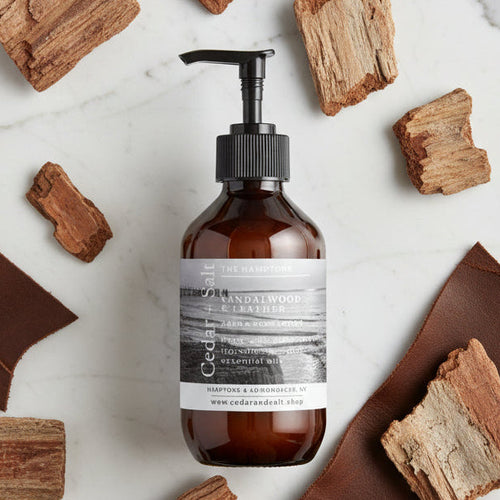 Brown bottle with black pump and white label on a light gray background