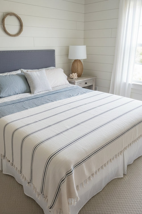 Bed with striped bedding in a bedroom setting