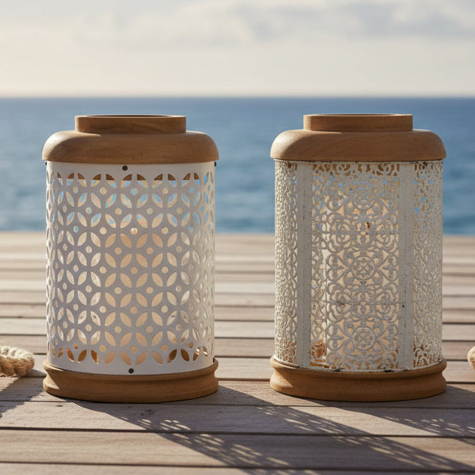 Two decorative lanterns with wooden tops and perforated metal bodies on a white background