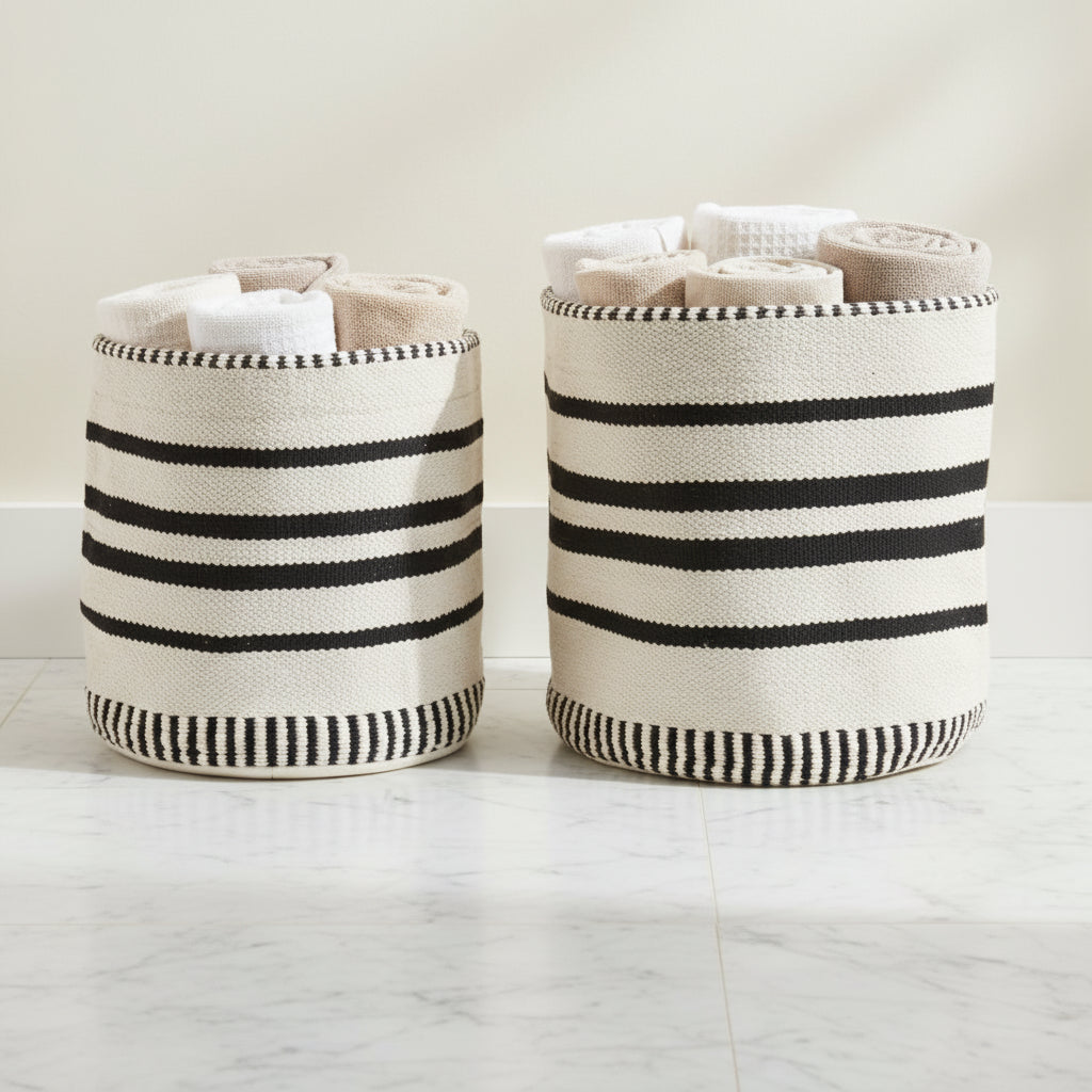 Two woven baskets with black and white striped patterns on a white background